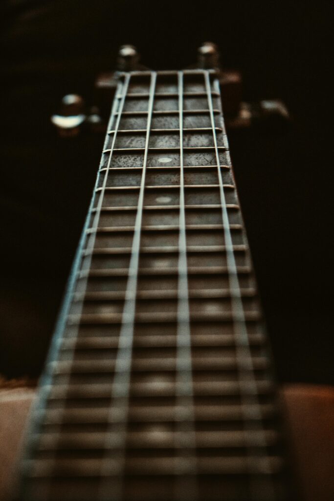 pexels-photo-1808343-1808343 Artistic close-up of a guitar fretboard focusing on the strings and frets with a depth of field effect.