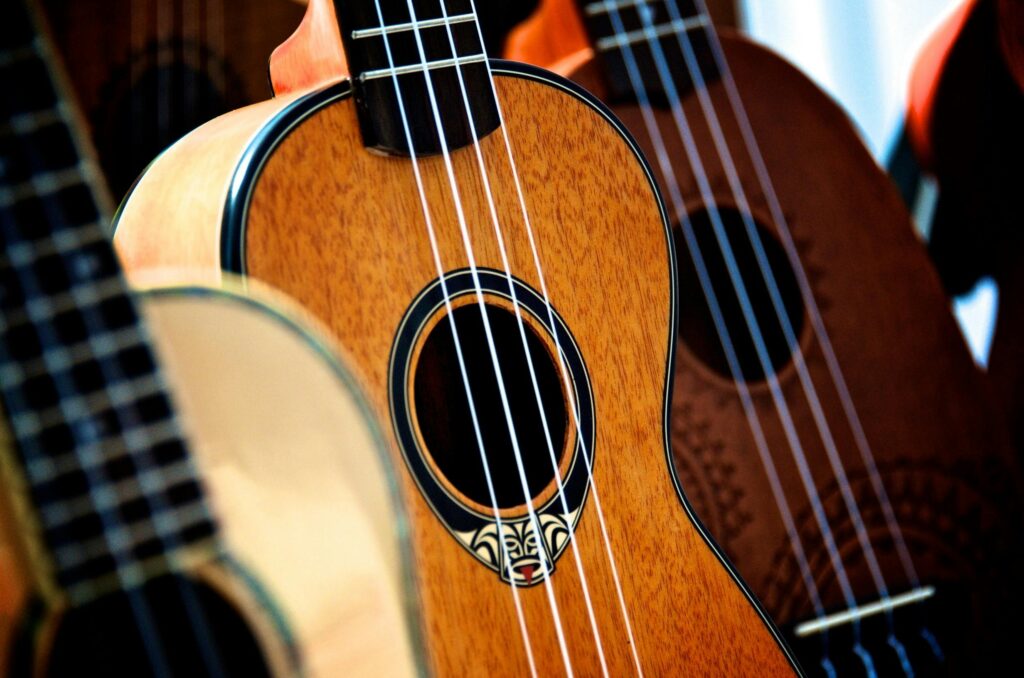 pexels-photo-258283-258283 Detailed view of classic acoustic guitars and ukuleles showcasing wooden textures and design.
