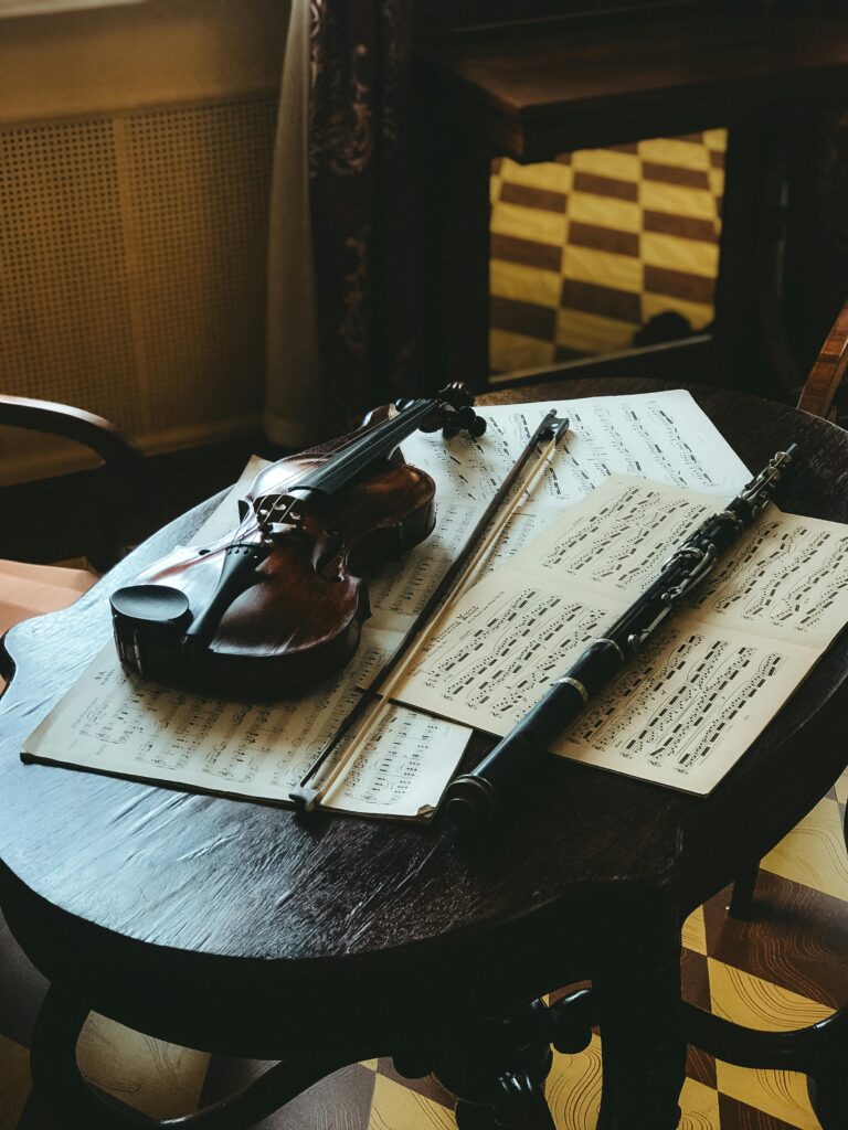 pexels-photo-10380835-10380835 Violin and sheet music on a wooden table, creating a vintage musical atmosphere.