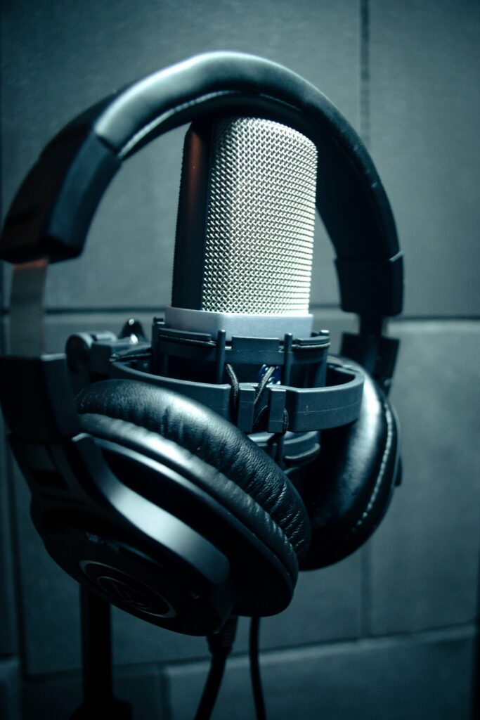 pexels-photo-3587475-3587475 Close-up of condenser microphone with headphones in a music studio.